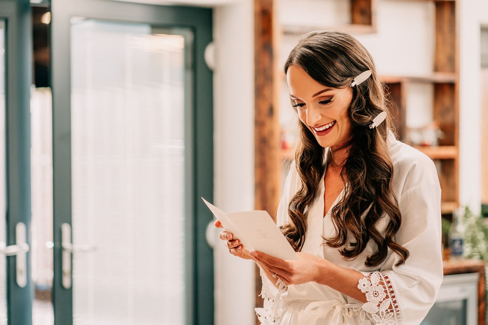 Beautiful bride reading a card from her groom