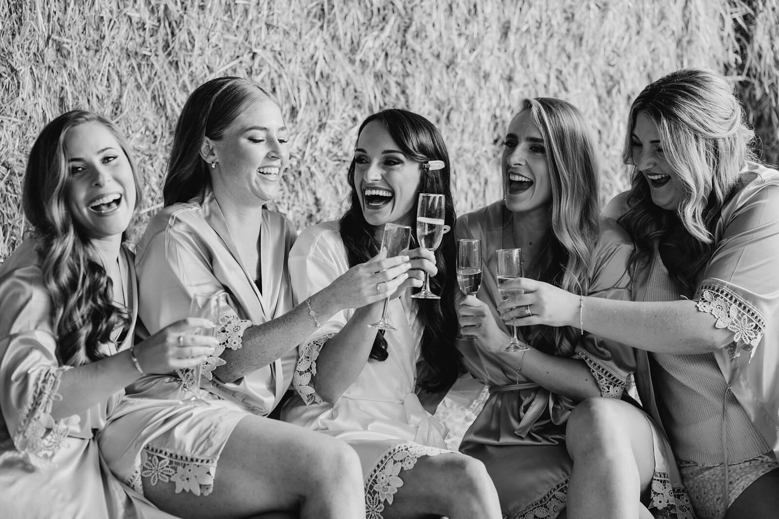 Bridesmaids and bride drinking champagne