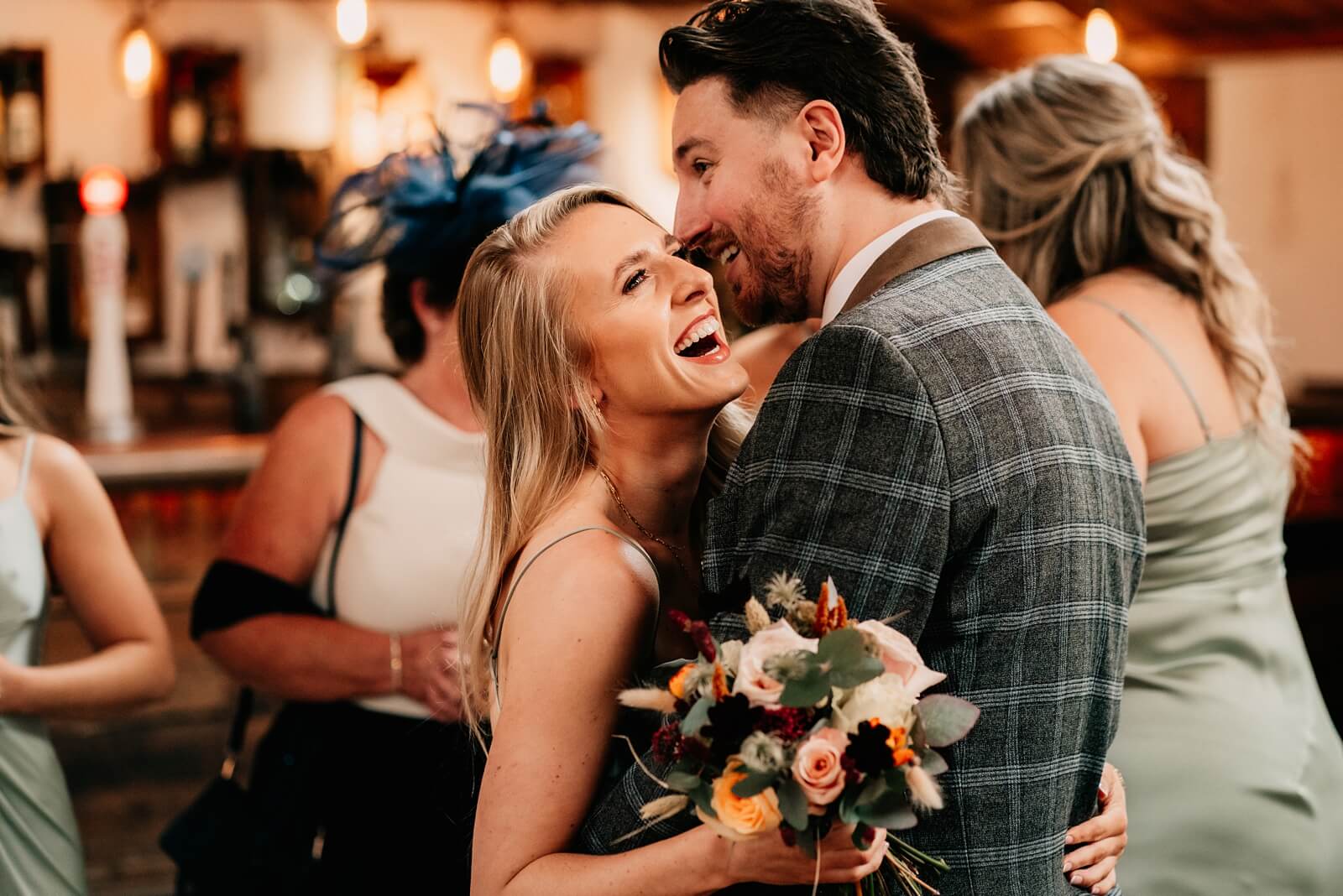 Guests laughing during the wedding drinks