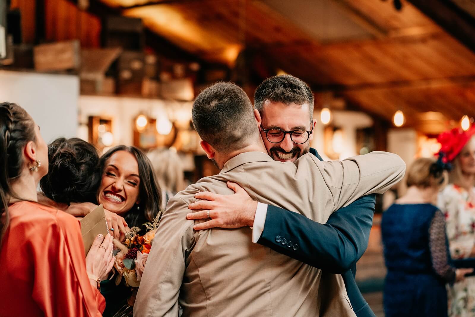 Groom and bride hugging guests