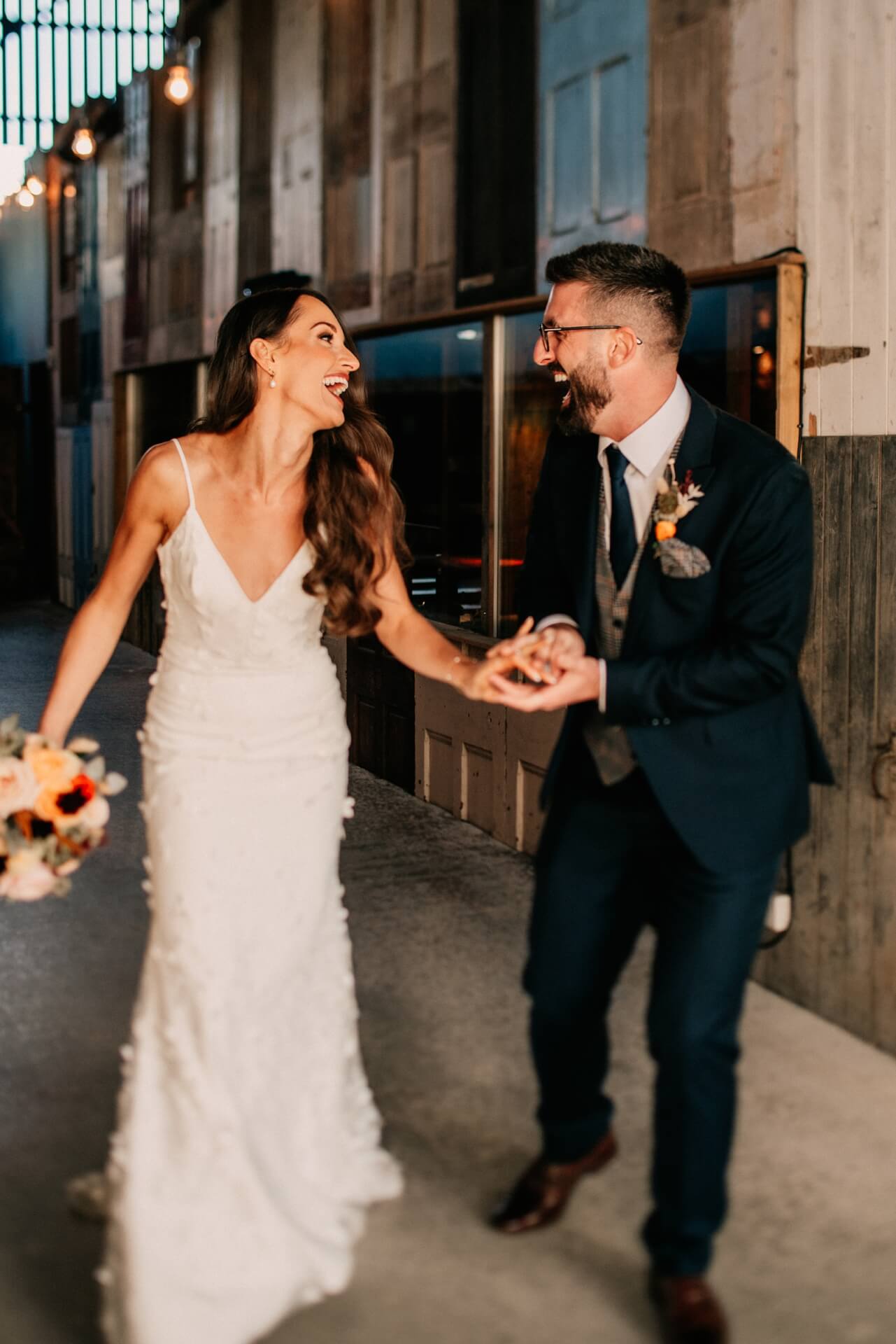 Bride and groom laughing during portraits