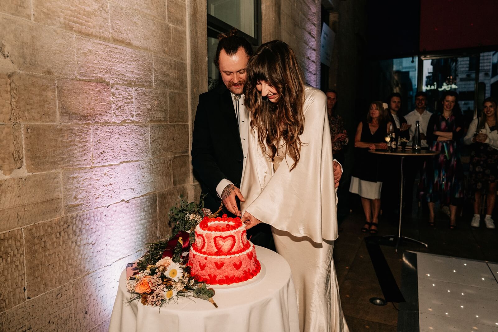Bride and groom cutting the cake