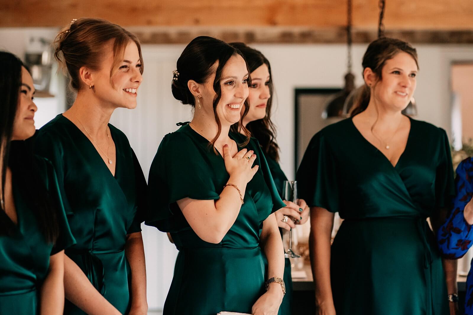 Bridesmaids wearing emerald green dresses