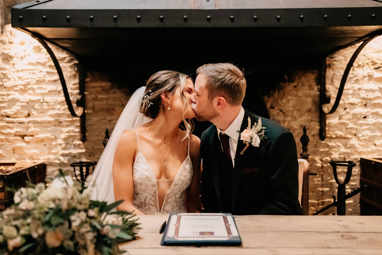 Bride and groom kiss during the ceremony