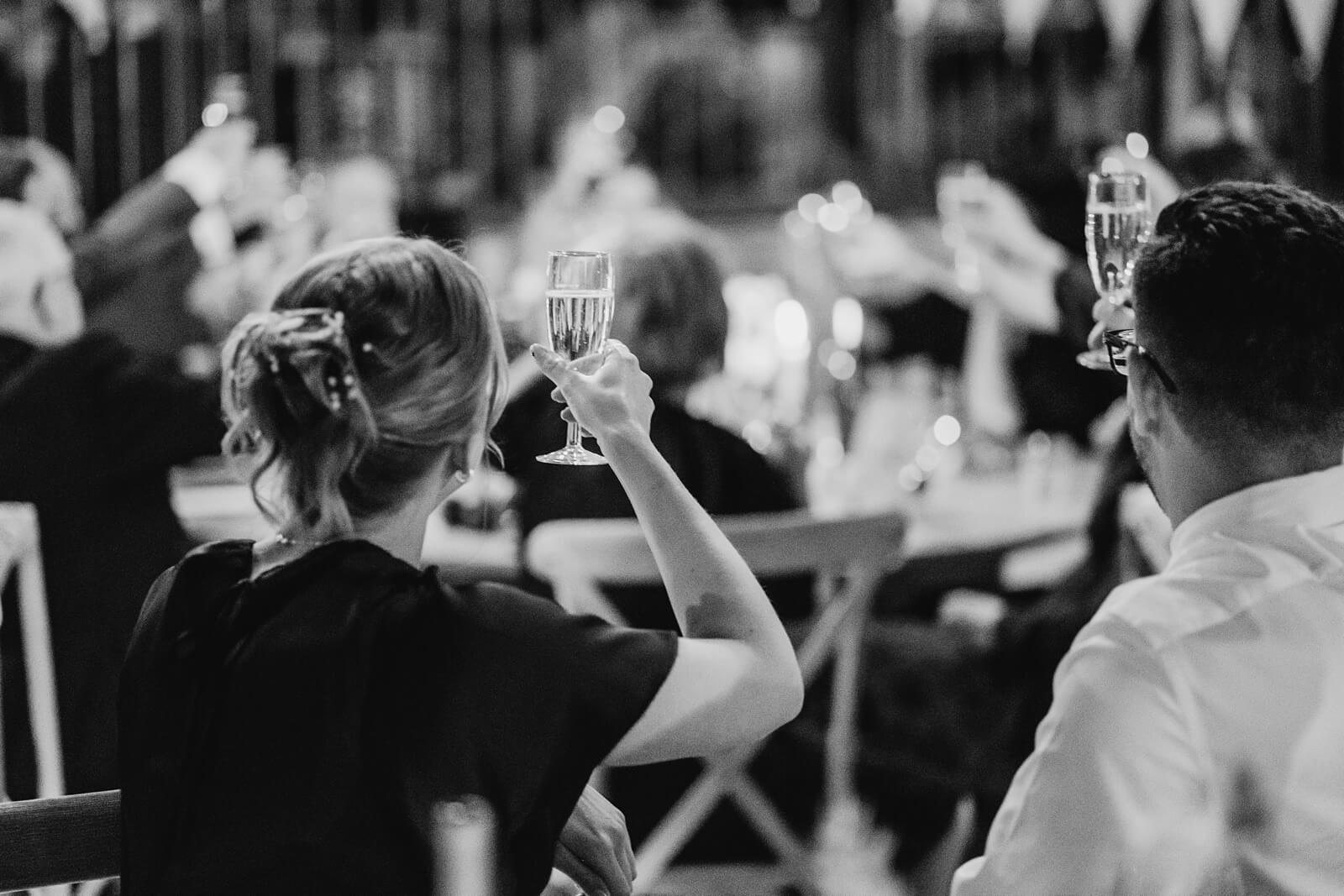 Guests holding champagne during speeches