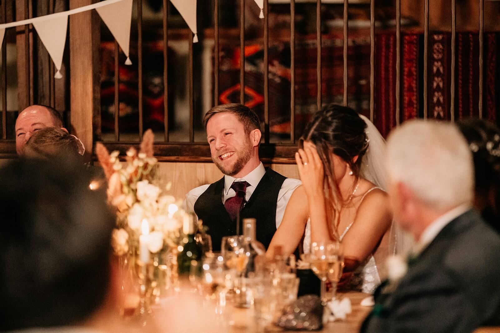 Groom laughing during the wedding speech