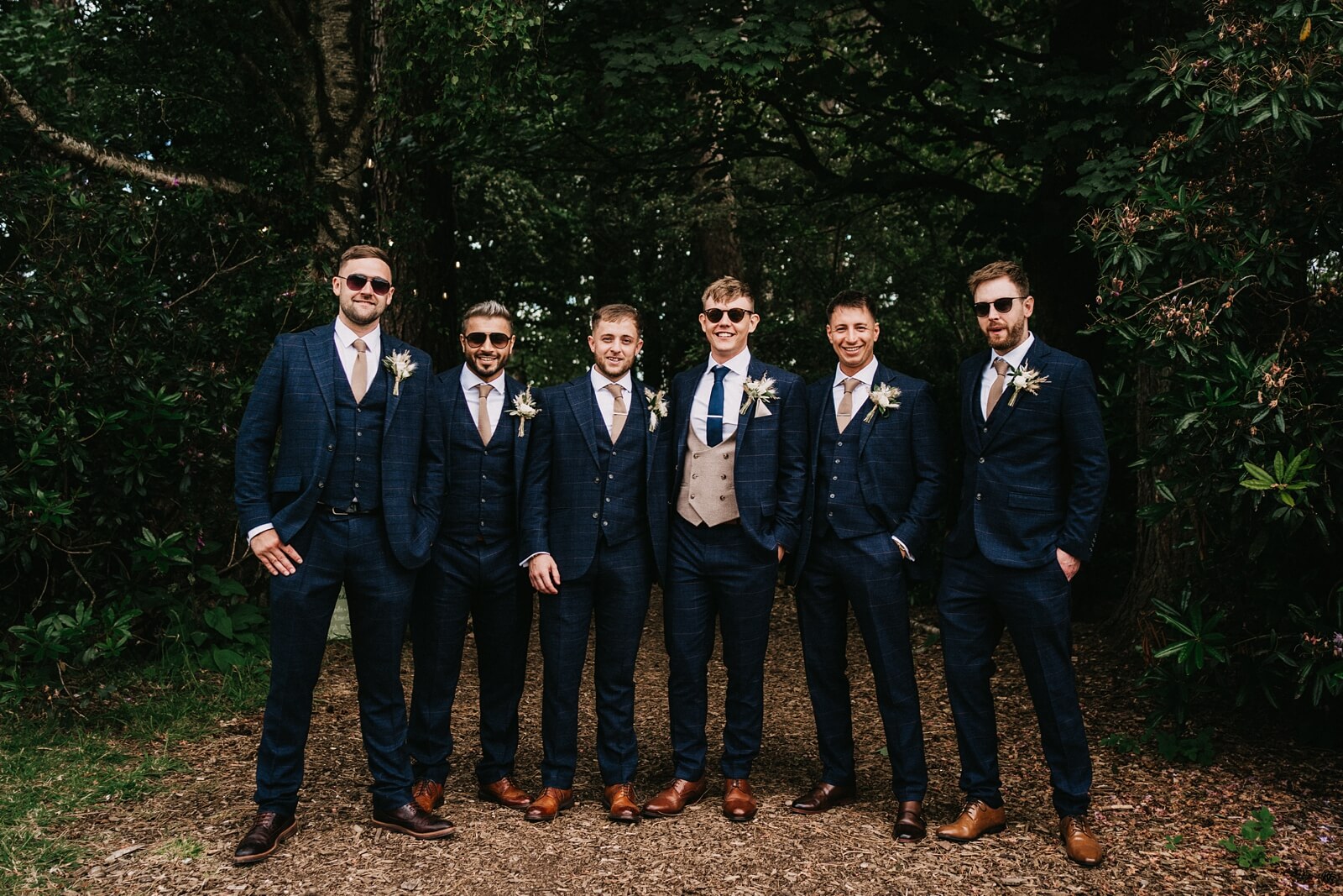 Groomsmen wearing navy suits