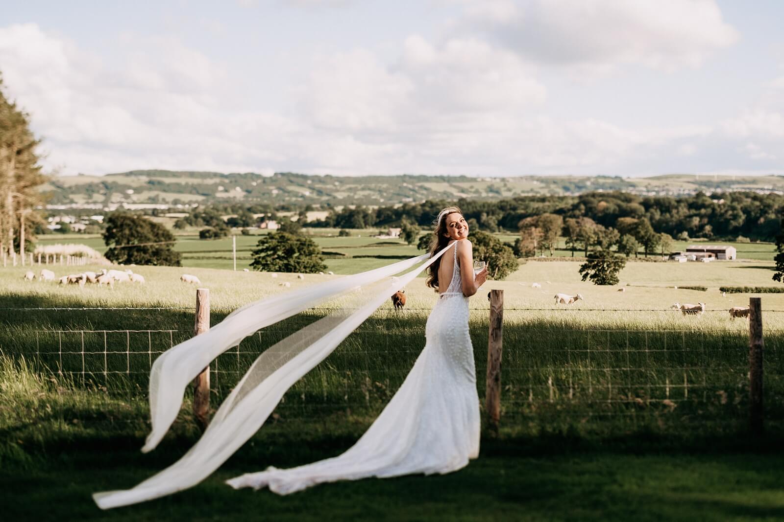 Bride wearing a floating veil and fitted wedding dress