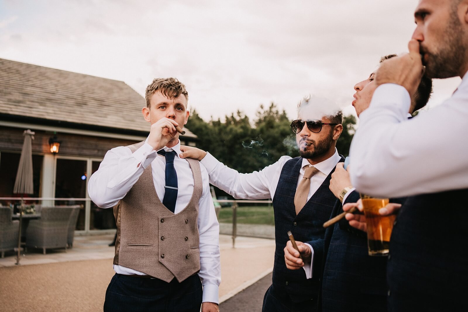 Groom and best men smoking cigars