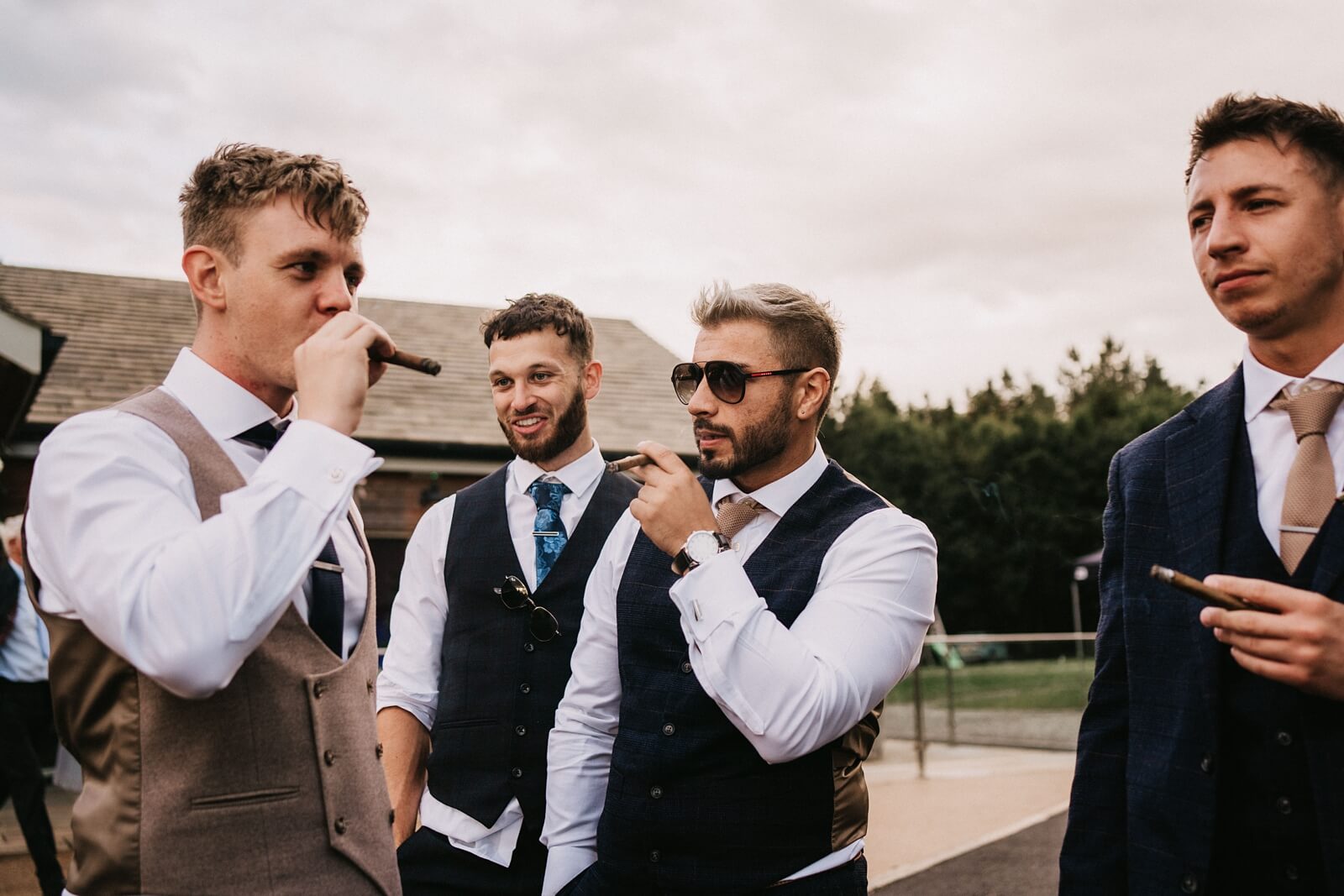 Groom and best men smoking cigars