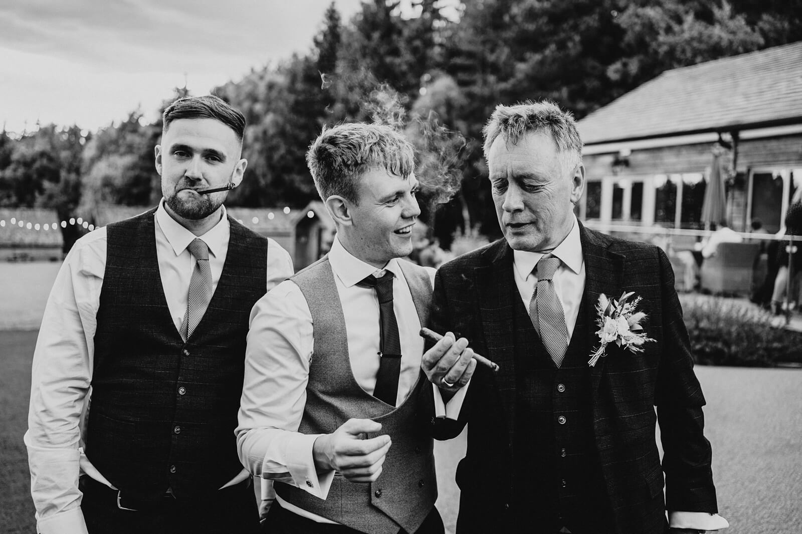 Groom and best men smoking cigars
