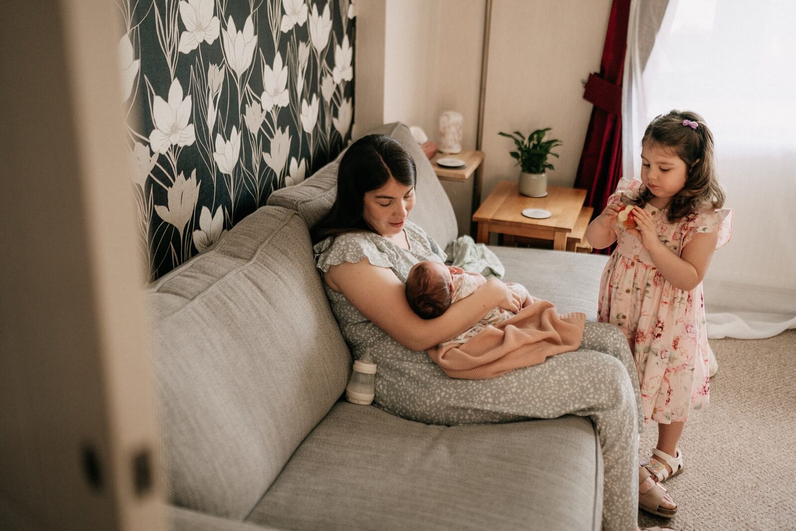 Mother feeding her baby during the photography session
